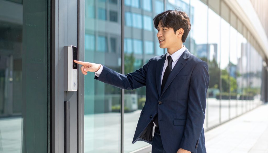 Asian employee using finger print recognition access control system